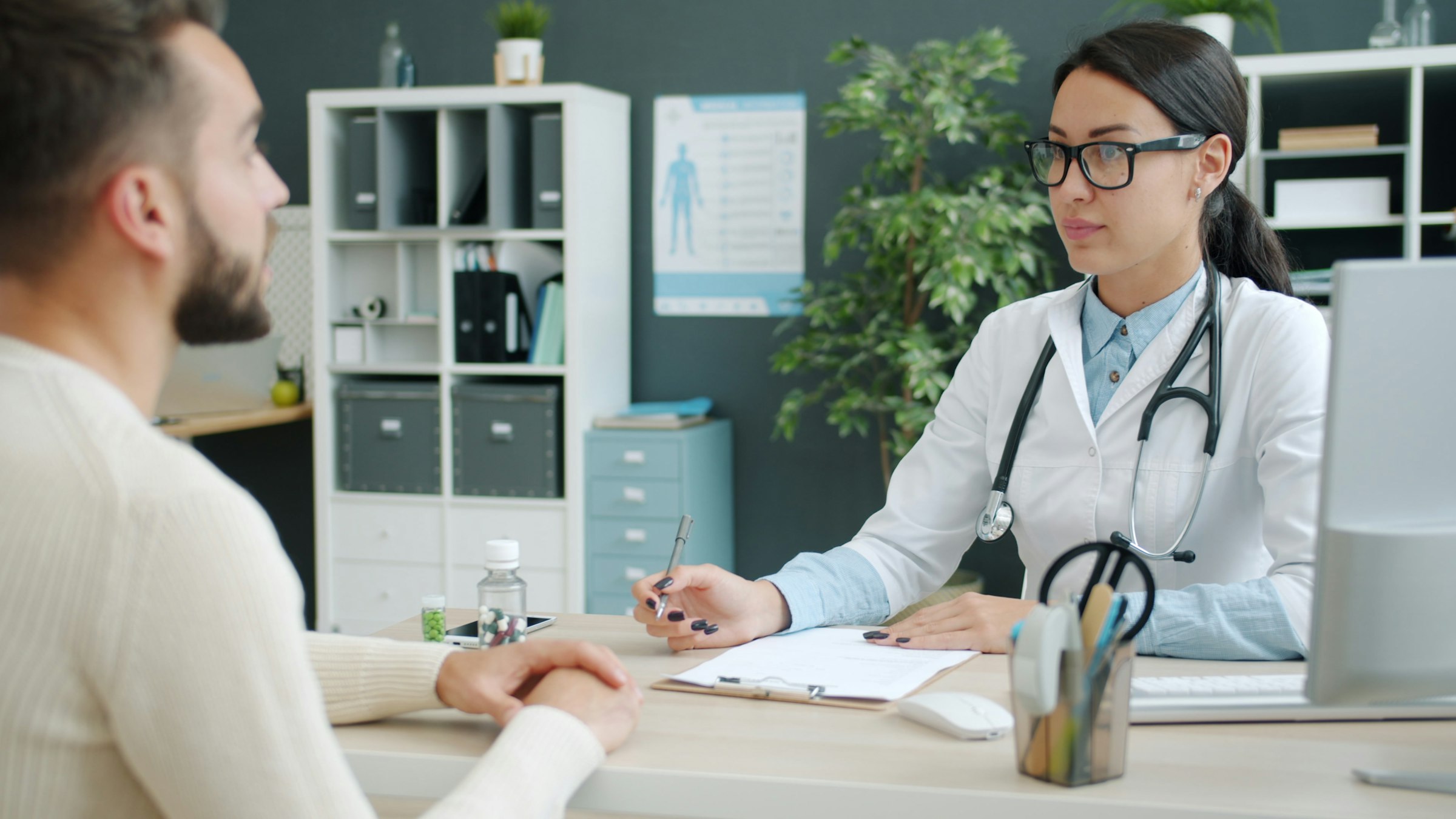 Doctor consulting a patient in an office during a detailed review