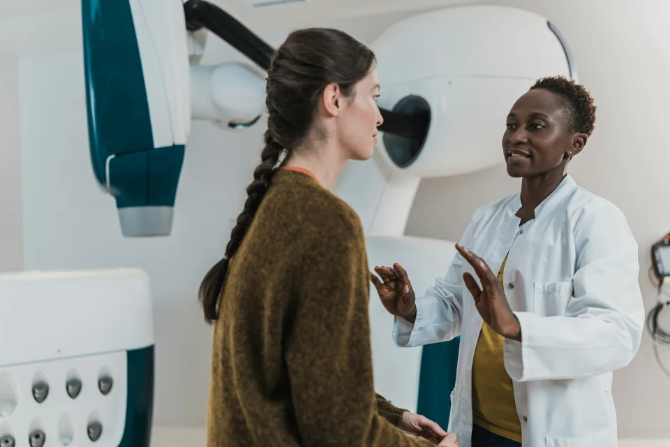 Medical professional speaking with a patient during treatment review